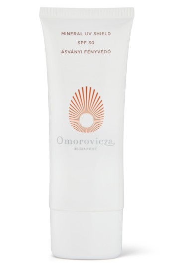 White tube of Omorovicza Mineral UV Shield Face Tanning Cream SPF 30, featuring a sunburst logo in orange and elegant branding, with a 100ml capacity.