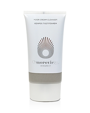 White tube with a silver cap, featuring a sunburst logo and "Omorovicza Budapest Moor Cream Cleanser" text, highlighting its 150ml size.