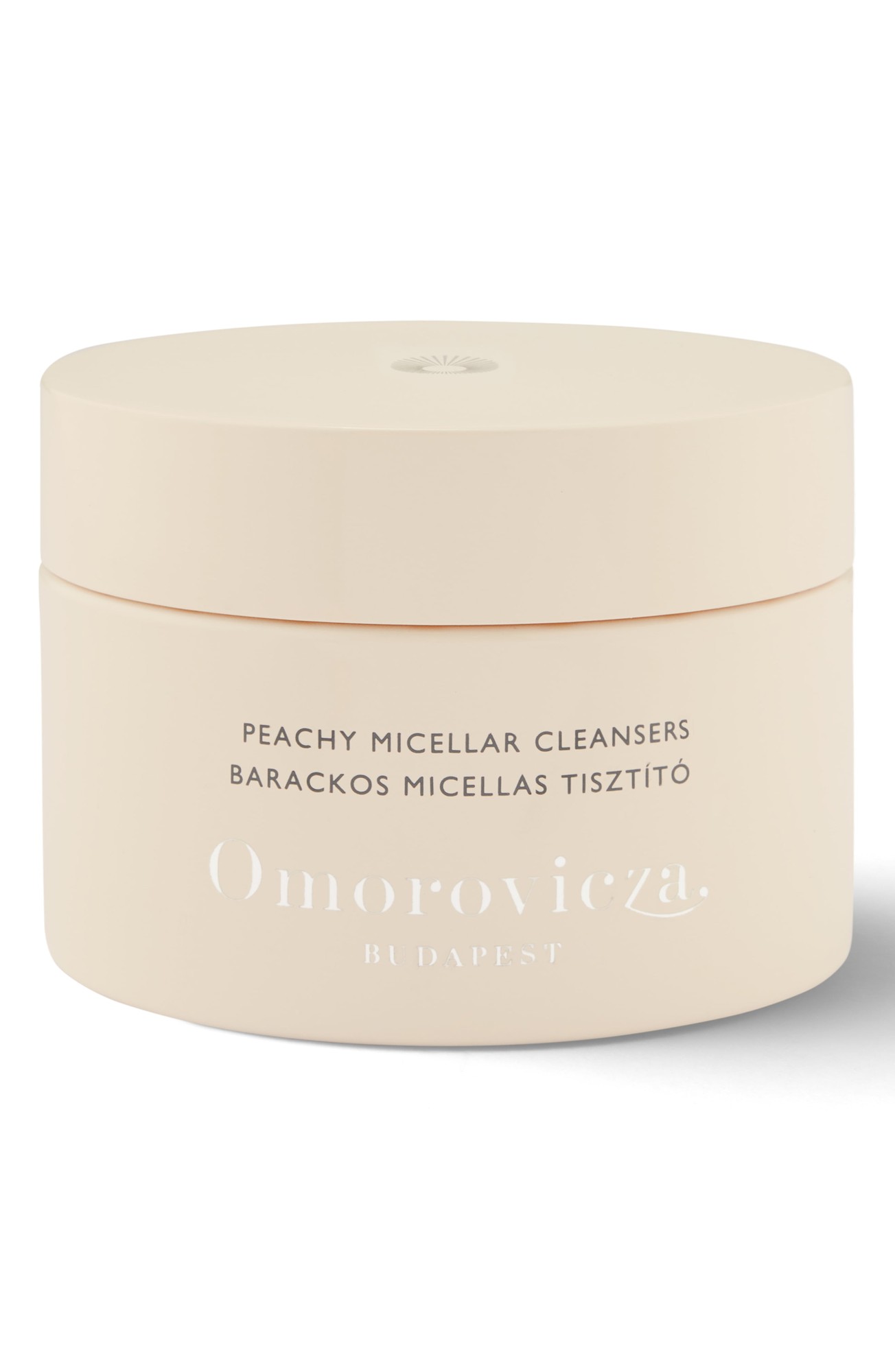 Light peach-colored jar with a smooth matte finish, featuring white text that reads "Peachy Micellar Cleansers" and "Omorovicza" embossed on the front.
