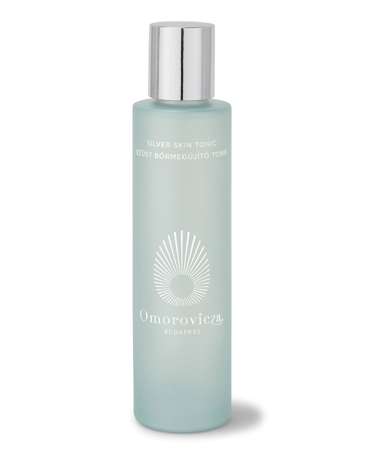 Frosted glass bottle of Omorovicza's Silver Skin Tonic, featuring a silver cap and white logo with a sunburst design, set against a plain background.