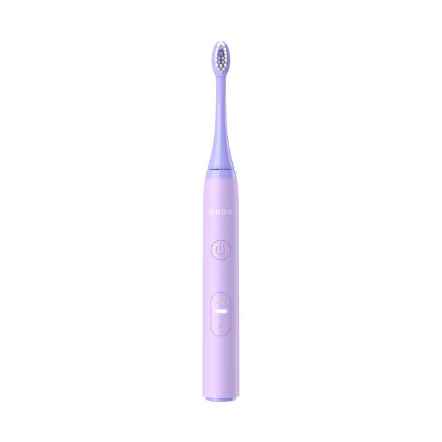 Lavender-colored Ordo Sonic Lite Electric Toothbrush with a sleek design, featuring a power button and a soft bristle head for effective cleaning.