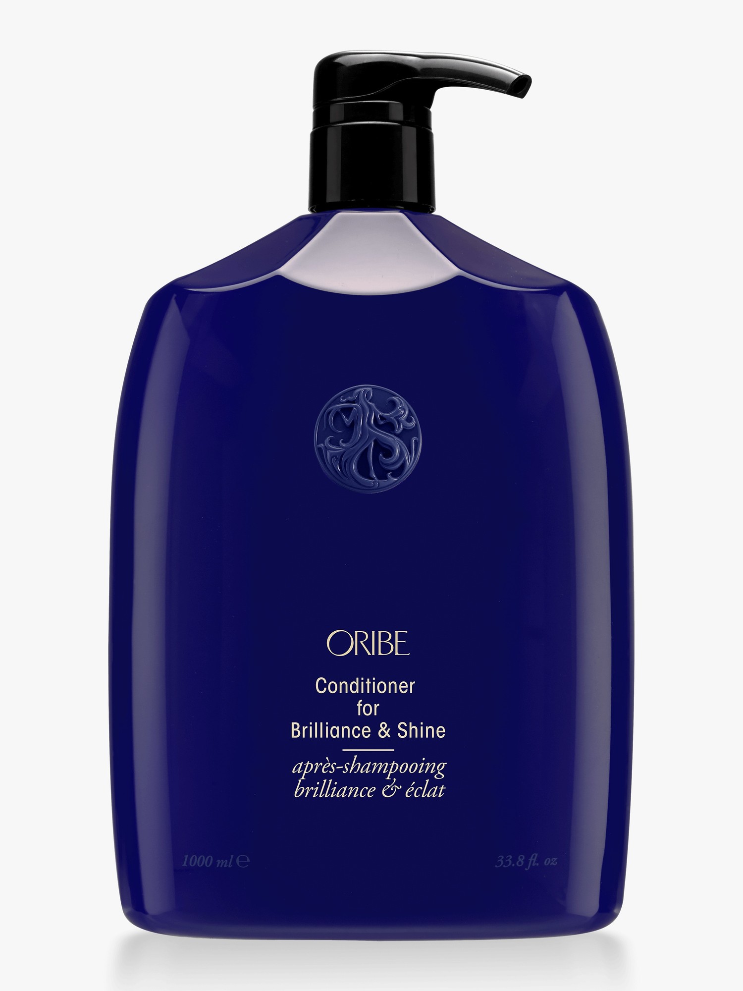 Deep blue plastic bottle with a black pump, labeled "Oribe Conditioner for Brilliance & Shine," featuring a silver logo and 33.8 oz capacity.