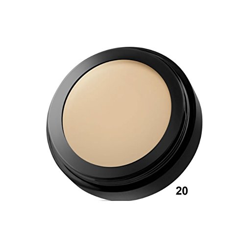 Round, black compact containing a creamy, beige camouflage cream labeled "20," designed for skin coverage with a smooth texture.