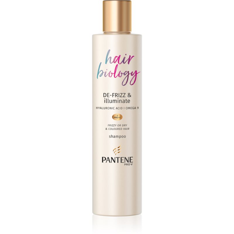 Tall, sleek bottle of Pantene Hair Biology De-Frizz & Illuminate Shampoo, featuring a gold cap, pastel gradient text, and a label highlighting hyaluronic acid and omega 9 for dry, color-treated hair.