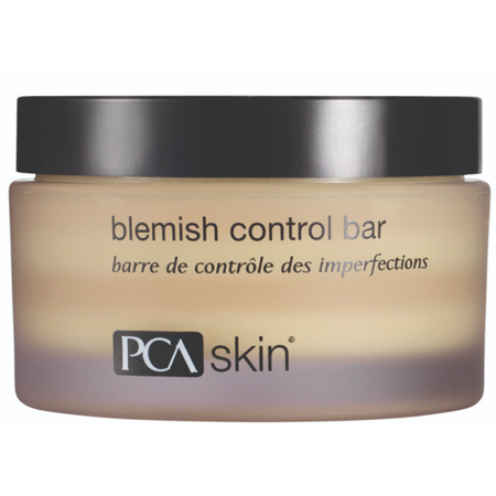 PCA Skin Blemish Control Bar Cleanser in a round, frosted jar with a black lid, featuring a gradient color from cream to lavender, labeled with "PCA skin" and product name.