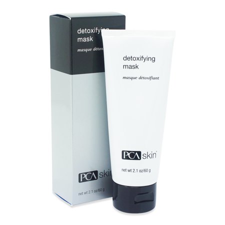 White tube with black cap labeled "Detoxifying Mask" by PCA SKIN, placed beside a sleek black and silver box, both emphasizing a clean, professional design.
