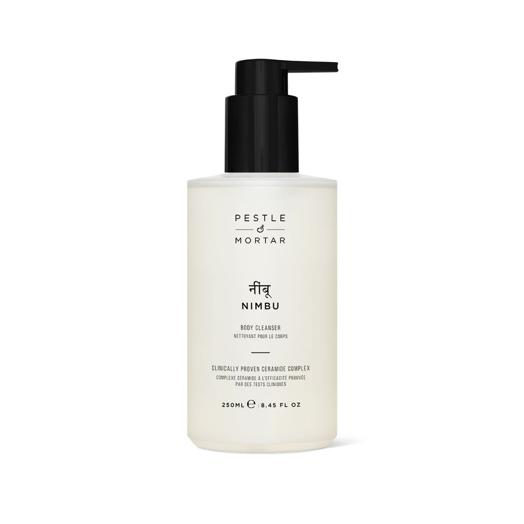 Clear bottle with a black pump top, labeled "Nimbu Body Cleanser" by Pestle & Mortar, featuring minimalist design and white text, containing 250ml of product.