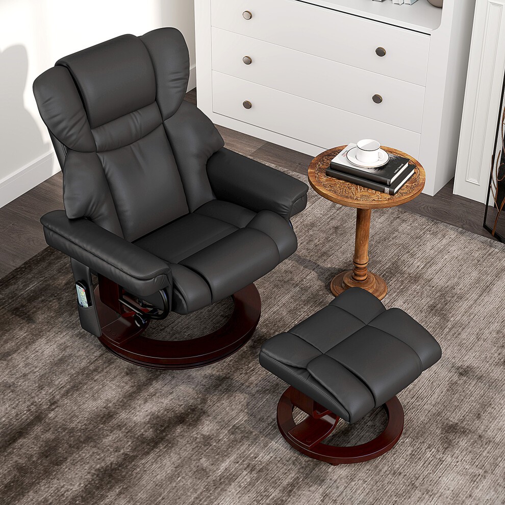 Black HOMCOM massage recliner chair with adjustable backrest, cushioned seat, and matching footstool, set on a wooden base, alongside a small round table with a coffee cup.