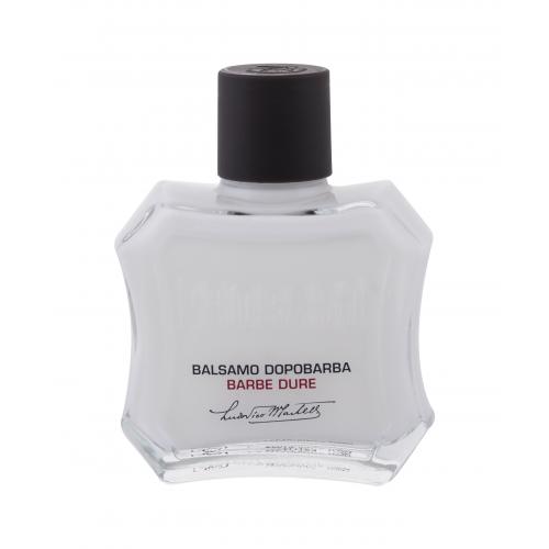 Clear glass bottle with a distinctive hexagonal shape, featuring a black cap, labeled "Balsamo Dopobarba Barbe Dure" in red and black text, containing 100ml of aftershave balm.