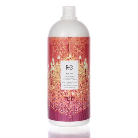 R+Co Bel Air Smoothing Conditioner in a 33.8oz white bottle featuring a vibrant pink label with a chandelier design and product details prominently displayed.