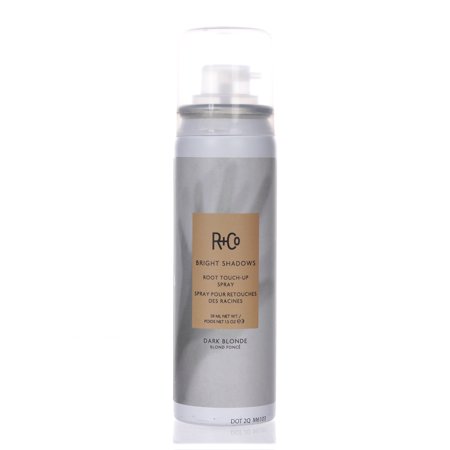 R+Co Bright Shadows Root Touch-up Spray in a sleek silver canister, labeled "Dark Blonde," featuring a pump nozzle and highlighting its transfer-free formula with amino acids.