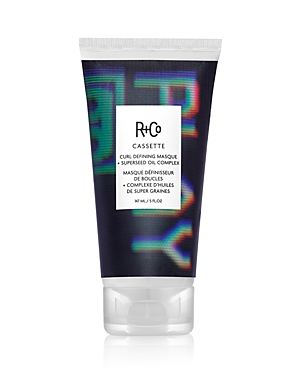 R+Co Cassette Curl Defining Masque in a sleek black tube, featuring vibrant holographic accents, labeled with product details and key ingredients like mango and avocado butter.