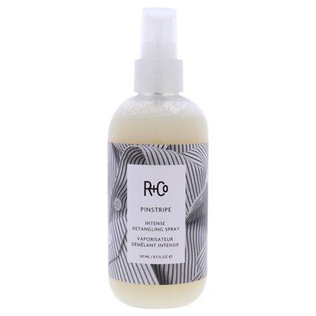 R+Co Pinstripe Intense Detangling Spray in a clear bottle with a white spray nozzle, featuring a black and white striped label with product details.
