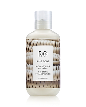 Clear plastic bottle with a white cap, featuring a label that reads "R+Co Ring Tone Ultra Defining Gel Crème," showcasing a design of white rings and containing 177ml of product.