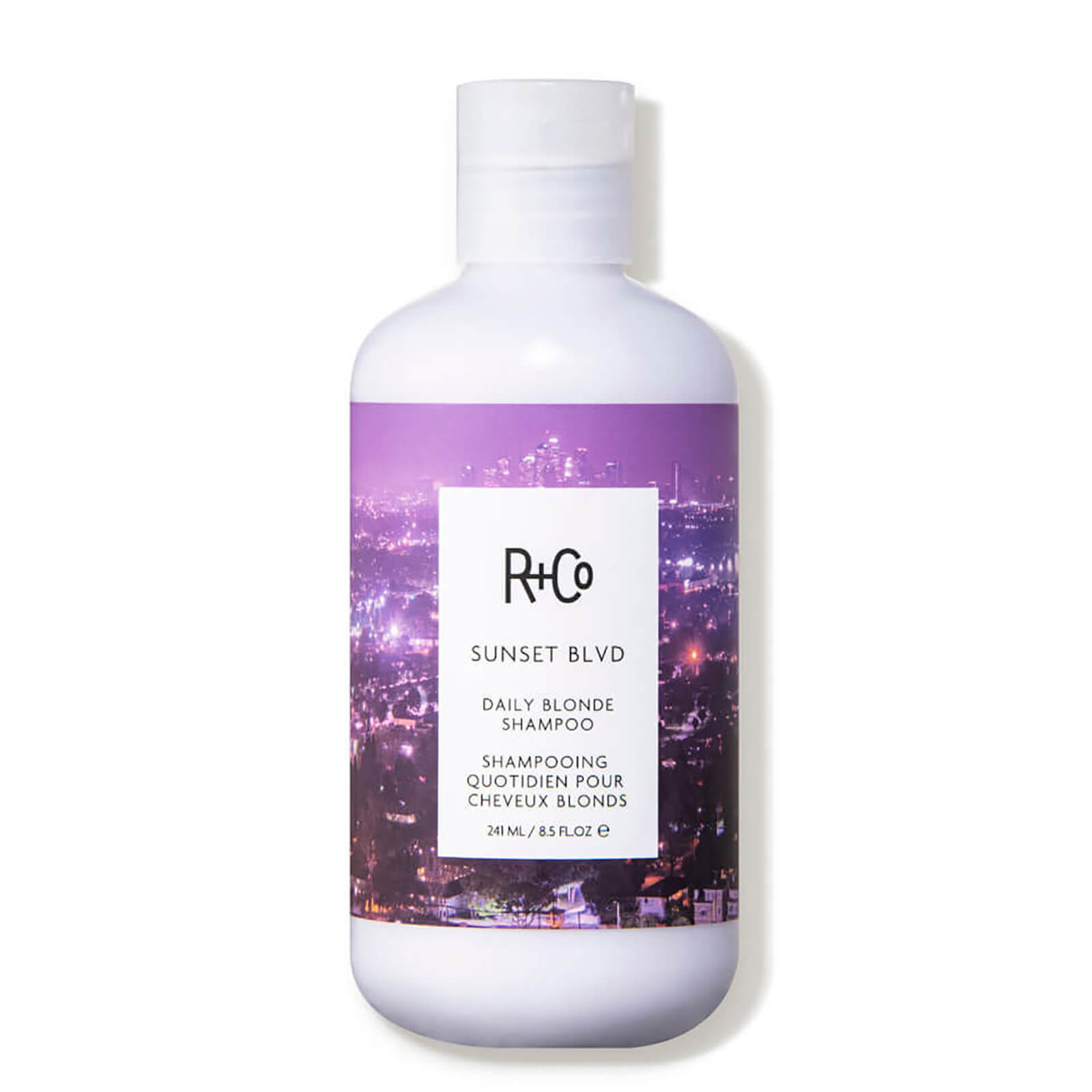 White bottle with a purple cityscape design, featuring the R+Co logo and "Sunset Blvd Daily Blonde Shampoo" label, 251ml/8.5oz size.