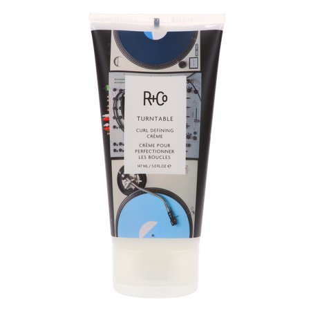 R+Co Turn Table Curl Defining Cream in a 147ml clear tube features a black and blue design with turntables, promoting nourishment and shaping of curls with rice protein.