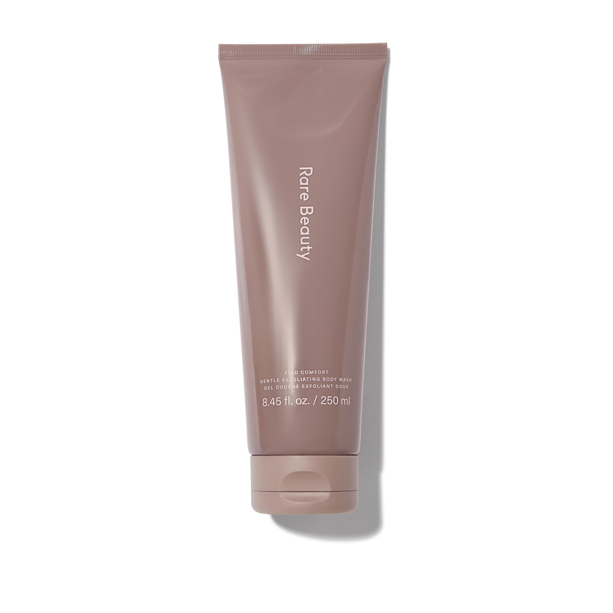 Light brown squeeze tube featuring "Rare Beauty" branding, labeled as "Find Comfort Gentle Exfoliating Konjac Jelly Body Wash," with a capacity of 8.45 fl. oz. / 250 ml.
