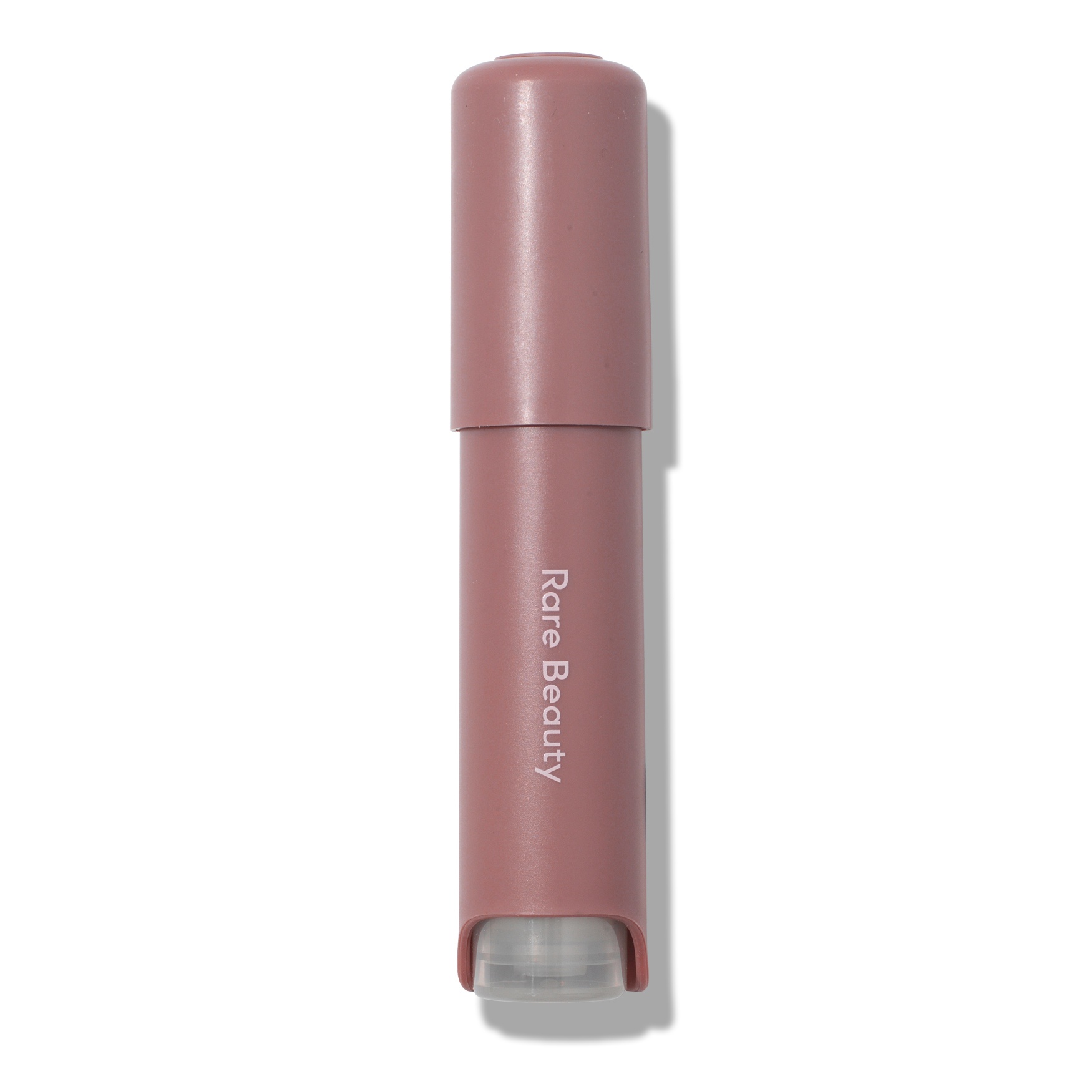 A pink aromatherapy pen with a clear rollerball tip, labeled "Rare Beauty," designed for soothing and comfort, measuring 0.16 oz / 5 ml.