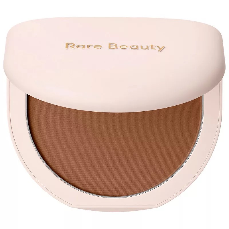 Rare Beauty's True to Myself Tinted Pressed Finishing Powder in Chestnut, featuring a smooth, matte surface in a warm brown shade, housed in a sleek, light pink compact with gold lettering.