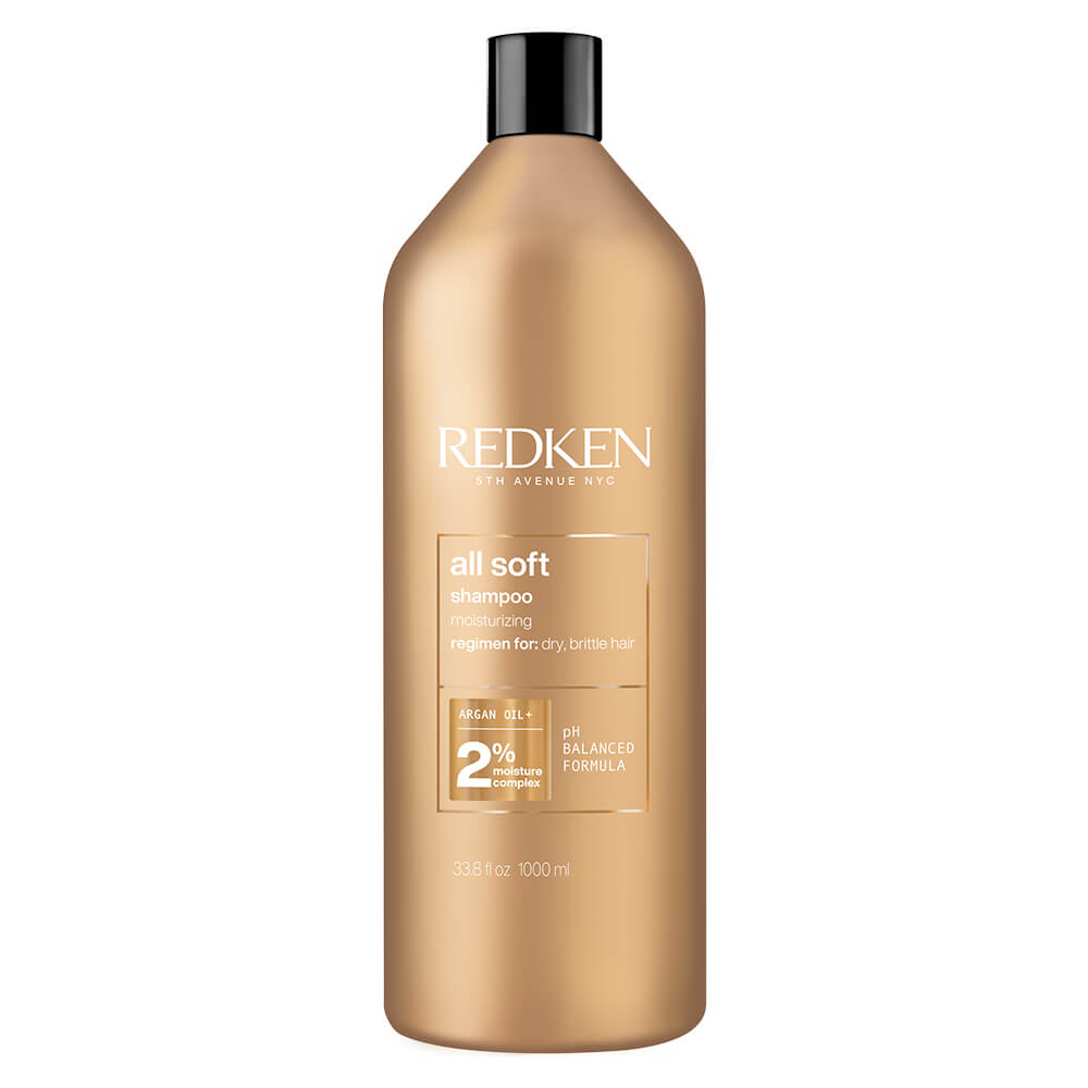 Gold-colored bottle of Redken All Soft shampoo, 1000 ml, featuring a white label with black text, highlighting moisturizing benefits for dry, brittle hair.