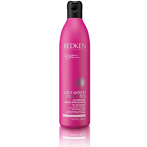 Bright pink bottle of Redken Color Extend Conditioner, 500ml, featuring a black flip-top cap and sleek design, labeled with product details in white text.