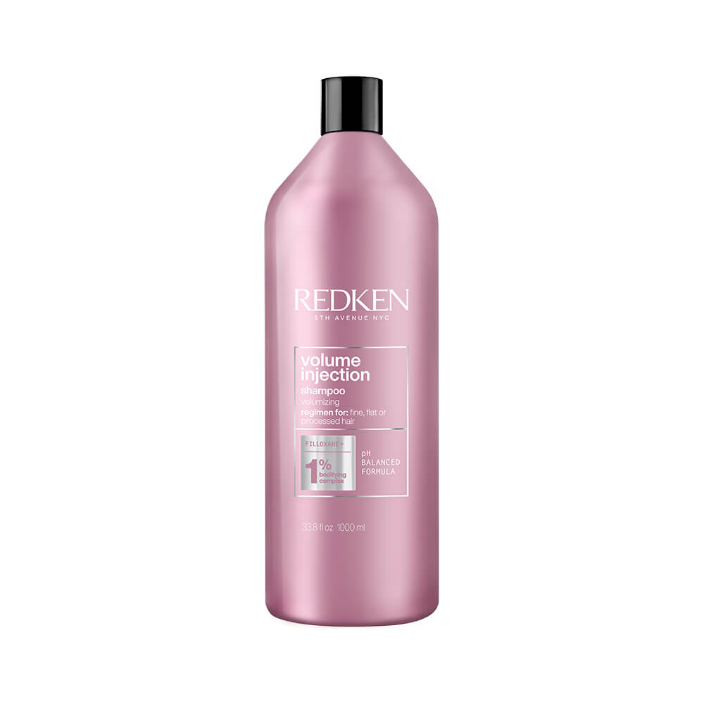 Pink plastic bottle of Redken Volume Injection Shampoo, 33.8 oz, featuring a sleek design with white text and a pump top, suitable for unisex use.