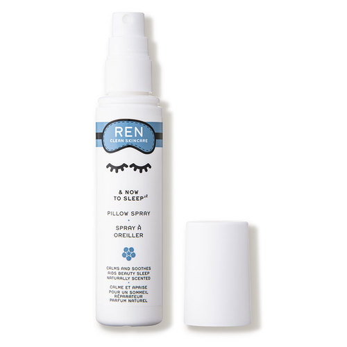 White spray bottle with a blue label featuring closed eyes, labeled "REN & Now to Sleep Pillow Spray 2.5oz / 75ml," with a removable white cap.