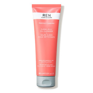 Coral-colored tube of REN Perfect Canvas Clean Jelly Oil Cleanser, 100ml, featuring a flip-top cap and minimalist branding on a white background.