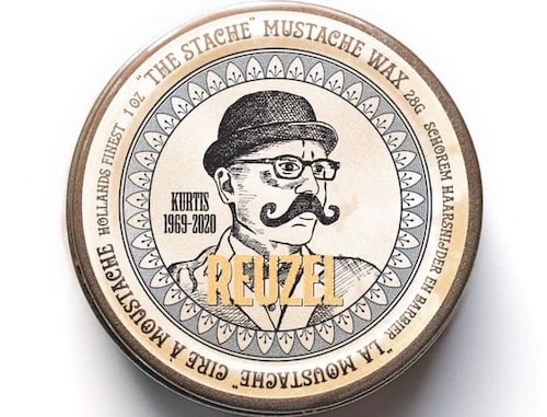 Round metal tin of Reuzel Mustache Wax, 28g, featuring a vintage illustration of a man with a mustache, labeled "Bourbon Sidecar Scent" and "Strong Hold."