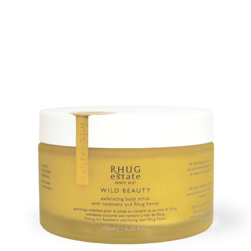 Clear yellow jar with a gold lid, labeled "Rhug Wild Beauty Exfoliating Body Scrub Rosemary & Rhug Honey," featuring a textured surface and a 280ml capacity.