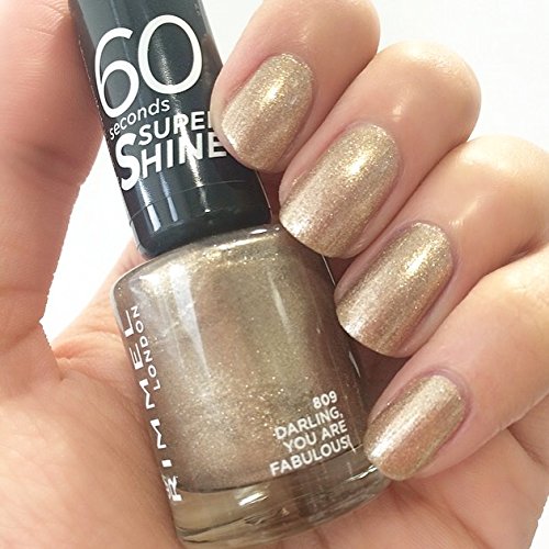 Debenhams 60 Seconds Super Shine Nail Polish in a sparkling gold shade, labeled "Darling You Are Fabulous," with a glossy finish applied on manicured nails.