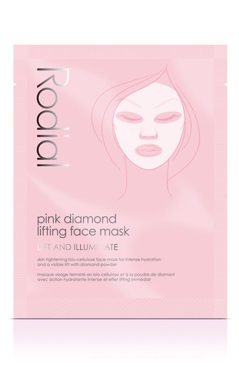 Rodial's Pink Diamond Lift and Illuminate Face Mask in a pink sachet featuring a minimalist design with a stylized face illustration and bold black text.