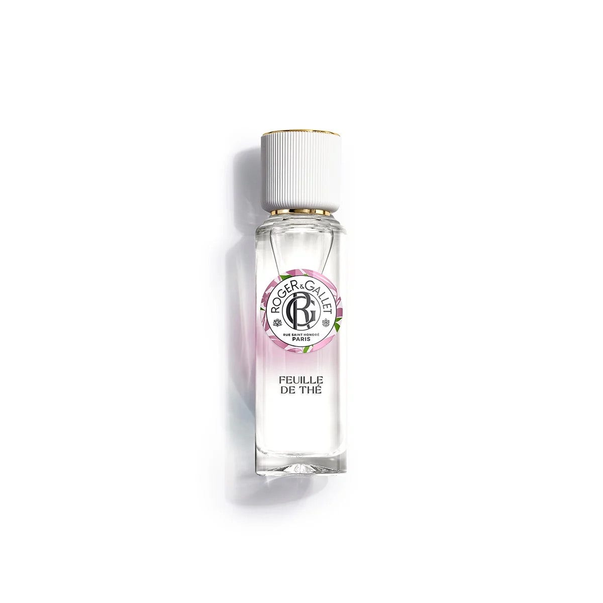 Clear glass bottle of Roger & Gallet Feuille De Thé fragrance, featuring a white cap and a colorful label with floral accents, containing 30ml of well-being scent.