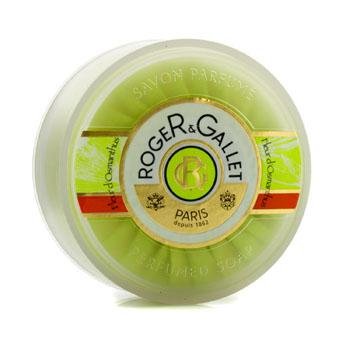 Round, pale green soap bar with a glossy finish, featuring a gold and white label with "Roger & Gallet" and "Fleur D'Osmanthus" text, set in a clear plastic packaging.