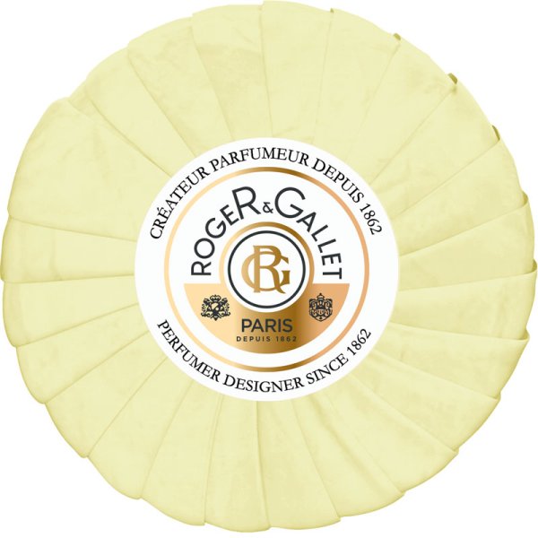 Round, pale yellow soap with a textured surface, featuring a white label in the center that displays the brand name "Roger & Gallet" and "Fleur D'osmanthus."
