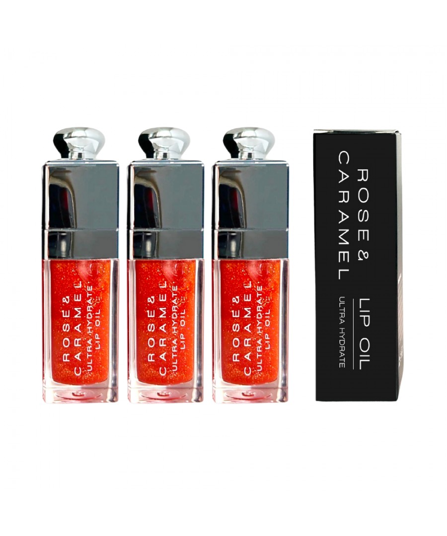 Three clear glass lip oil bottles with a shiny silver cap, filled with a vibrant red-orange oil, alongside a sleek black box labeled "Rose & Caramel Lip Oil."