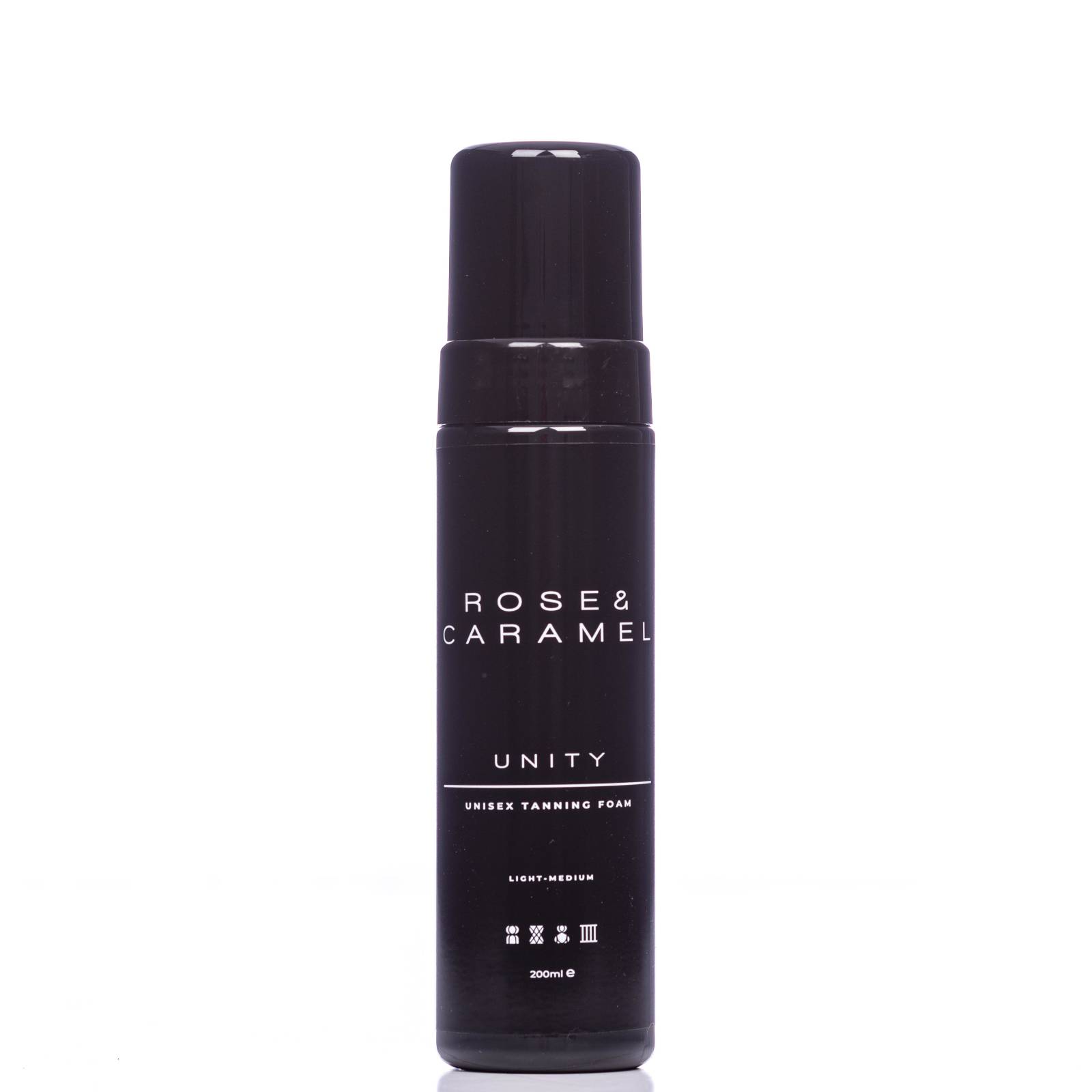 Debenhams Unity Tanning Foam by Rose & Caramel in a sleek black bottle, featuring white text, labeled as unisex and light medium, with a pump dispenser on top.