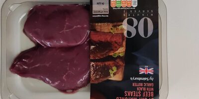 Two deep red beef steaks packaged with a black and white label, featuring a photo of cooked steak, nutritional information, and a British flag emblem.