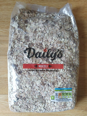 Clear plastic bag filled with light brown muesli, featuring whole oats, seeds, and dried fruits, labeled "Dailys Muesli" in bold black and red text with nutritional information on the side.