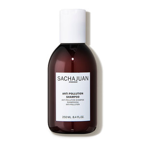 Brown glass bottle with a white flip-top cap, labeled "SACHAJUAN ANTI POLLUTION SHAMPOO" in black text, containing 8.4 oz of shampoo.