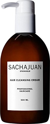Brown glass bottle with a white pump dispenser, labeled "SACHAJUAN HAIR CLEANSING CREAM," featuring a minimalist design and professional haircare details, 500 ml.
