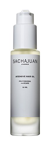 Clear glass bottle with a white pump top, labeled "SACHAJUAN INTENSIVE HAIR OIL," containing a light yellow oil, designed for unisex hair care, 1.7 oz.