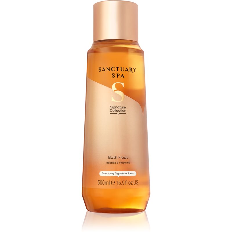 Transparent bottle of Sanctuary Spa Signature Bath Foam, featuring a golden liquid, a rose gold cap, and a label with the Sanctuary Spa logo and product details.