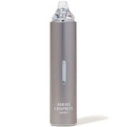 Sleek silver skincare device with a transparent top, featuring a central window and the brand name "Sarah Chapman" in white, designed to warm and soften skin while refining pores.