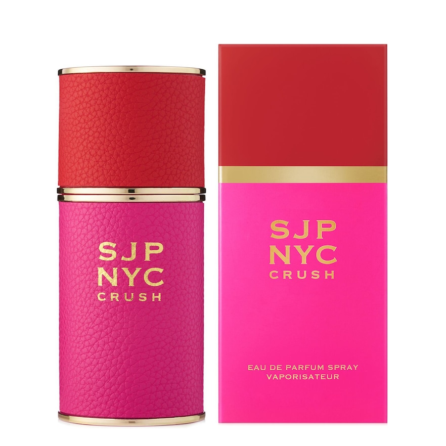 Red and pink textured cylindrical perfume bottle with gold accents, accompanied by a vibrant pink and red box featuring "SJP NYC CRUSH" in bold gold lettering.