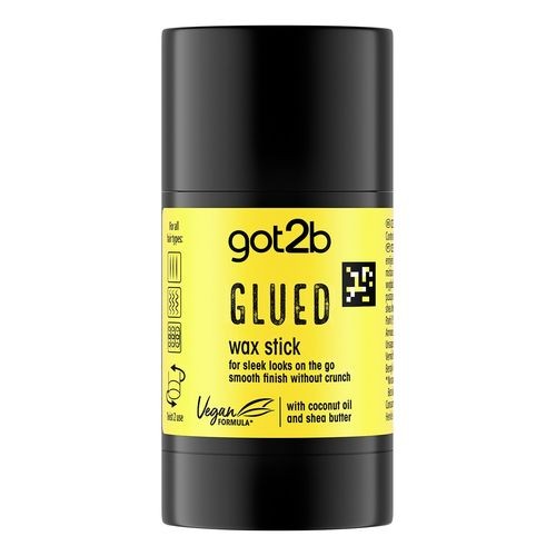 Black cylindrical container with a bright yellow label, featuring the text "Glued Wax Stick" and details about its vegan formula, coconut oil, and shea butter.