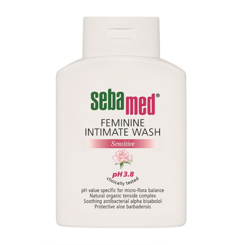 White plastic bottle with a flip-top lid, labeled "Sebamed Feminine Intimate Wash," featuring a pink logo and details about pH 3.8 and sensitive skin formulation.