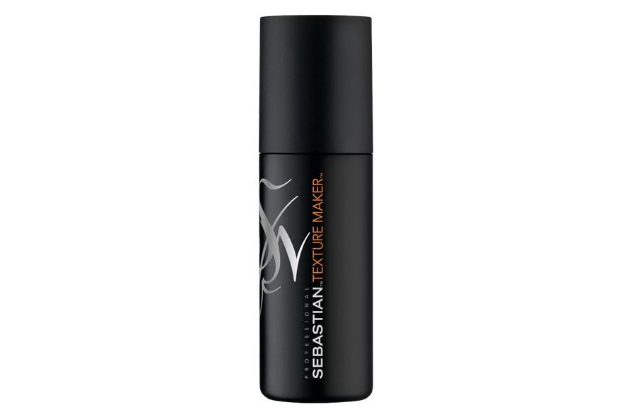 Black spray bottle with a sleek design, featuring a matte finish and an orange and white logo, labeled "Sebastian Professional Texture Maker" in bold lettering.