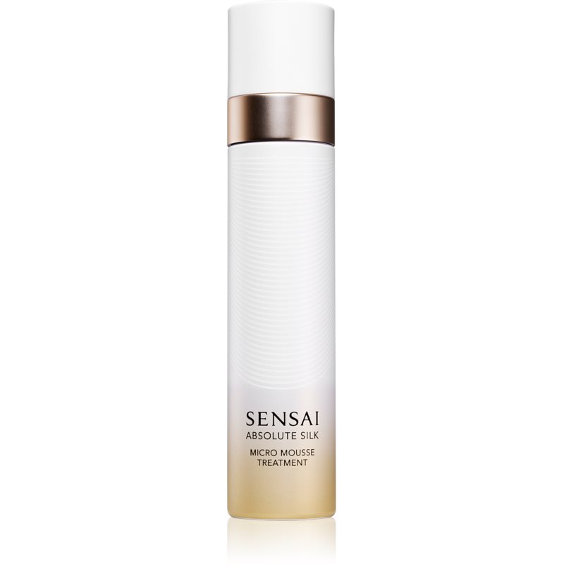 White cylindrical bottle with a textured surface, gold and rose gold accents, labeled "SENSAI ABSOLUTE SILK MICRO MOUSSE TREATMENT 90 ML" in elegant font.