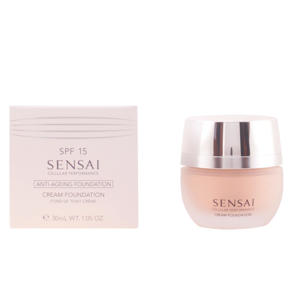 Soft beige cream foundation in a sleek, round glass jar with a silver lid, accompanied by a light pink box featuring the Sensai logo and product details.